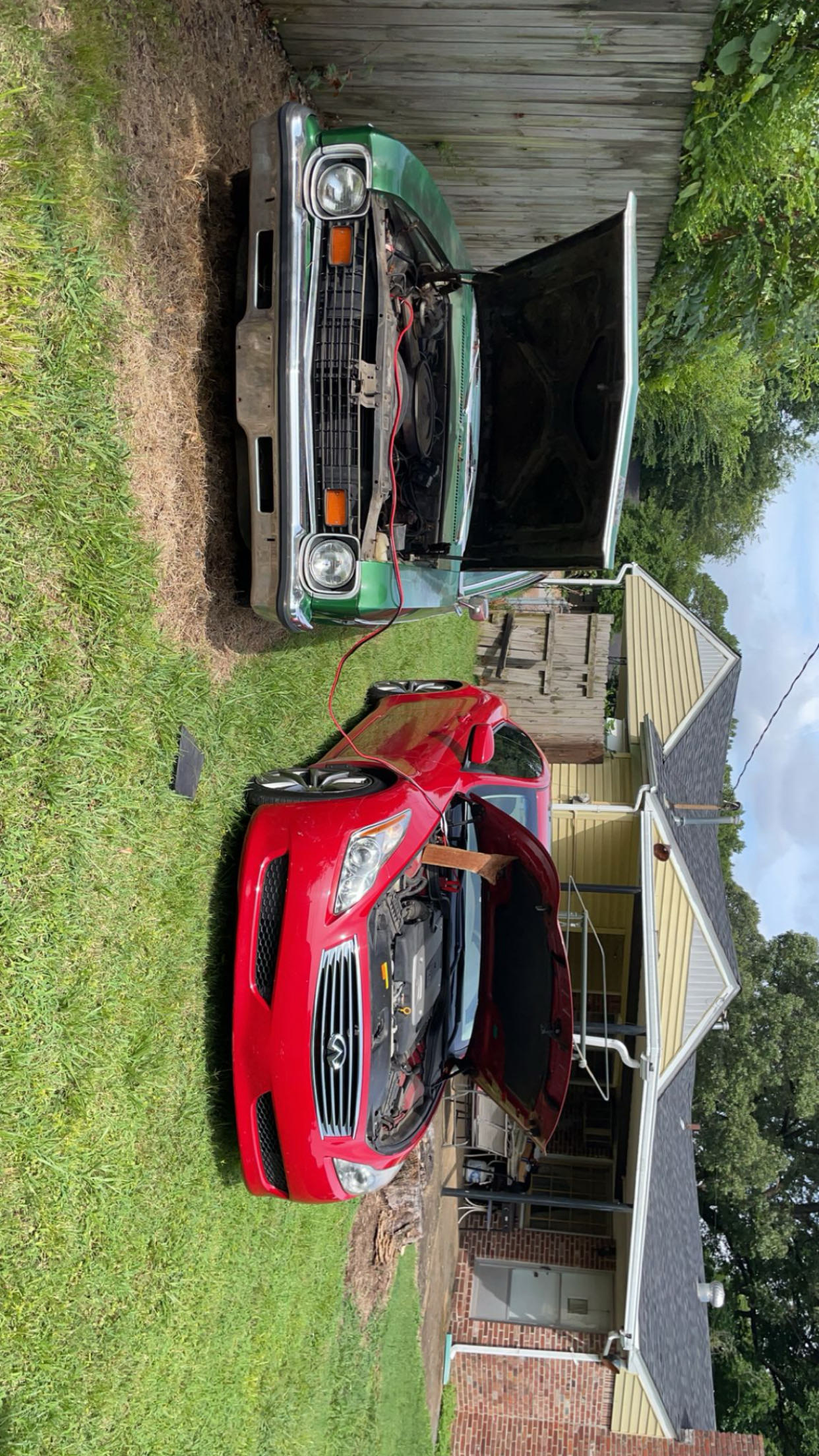 1973 Chevy Nova being jump started by an Infiniti G37